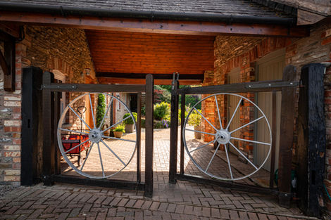 Wooden gates with wagon wheels, Cherry Tree Lodges