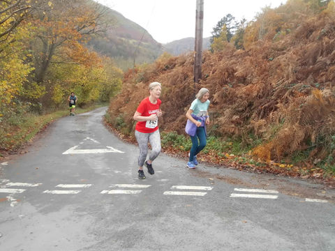 Two women in a race running on a road, Rhayader Running Club.