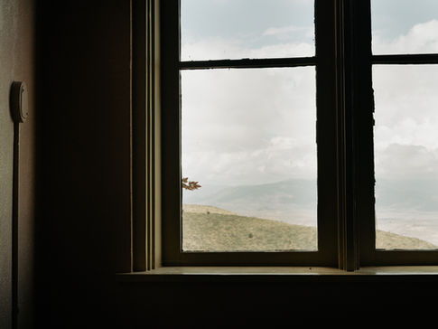 Room corner with part of a window and view onto a landscape 