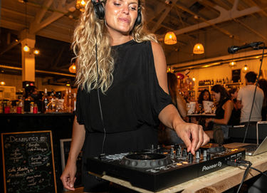 Female DJ mixing music at a party
