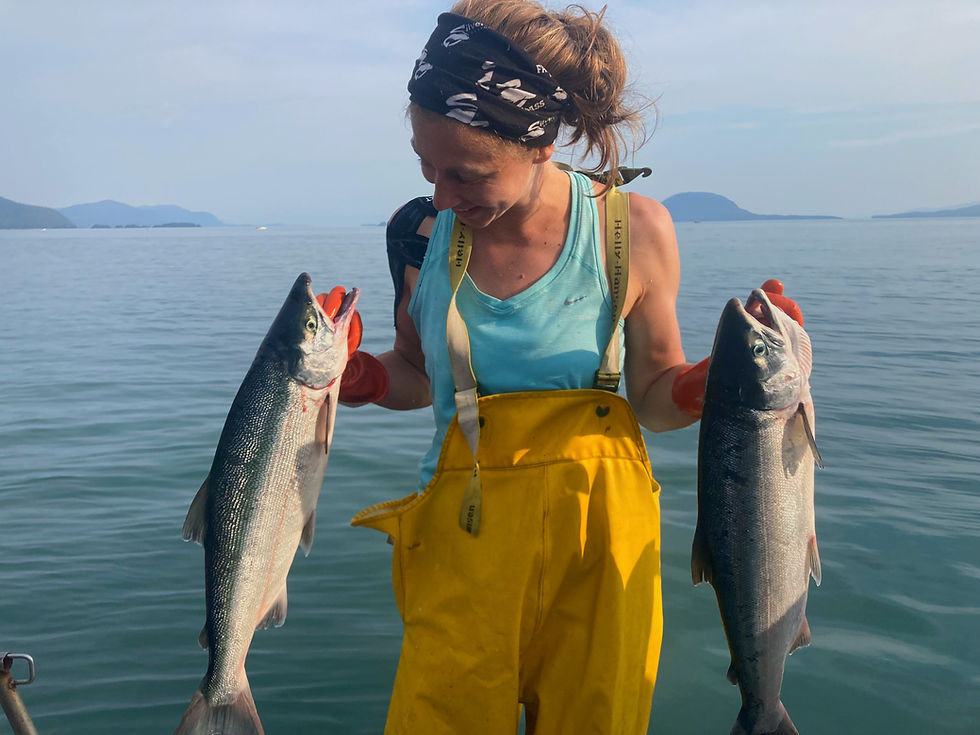 Thumbnail: Ilsa the fisher with two wild caught sockeye salmon