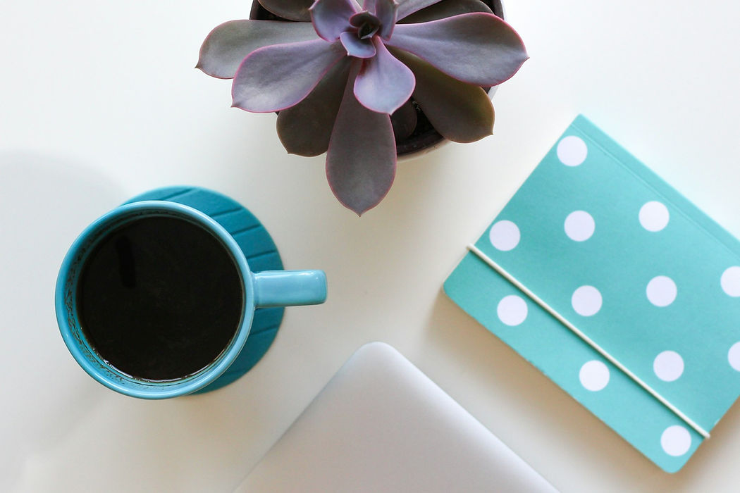 desktop workspace coffee plant book.jpg