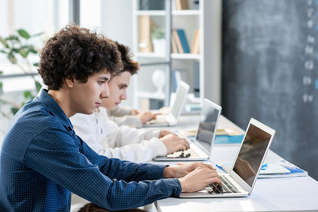 side-view-two-guys-sitting-by-desk-row-front-laptops-preparing-presentation-new-software-o