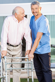 male caregiver assisting senior with walker