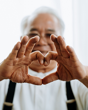 Elderly Man Making a Hand Heart