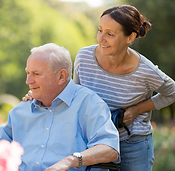 senior in wheelchair with smiling woman