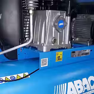 Close up view of electric motor on industrial air compressor unit