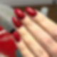 Glamorous set of long pointed almond shaped nails with a sparkly deep red glitter gel polish
