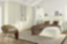 Cosy bedroom with cream wardrobes, a bed with white sheets and brown pillows