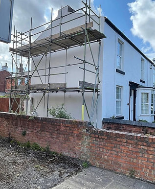 Residential house with dark grey spray cork render coating