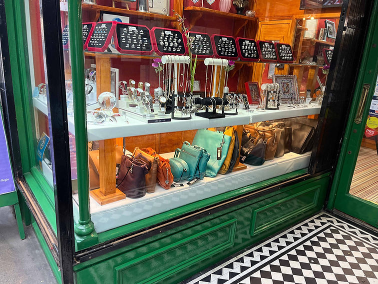 A jewelry and accessory shop window display featuring elegant watches