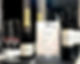 Bottles of champagne standing next to a framed treatment price list menu on a counter in a Shrewsbury salon