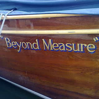 Close-up of polished wooden boat side displaying the words "Beyond Measure