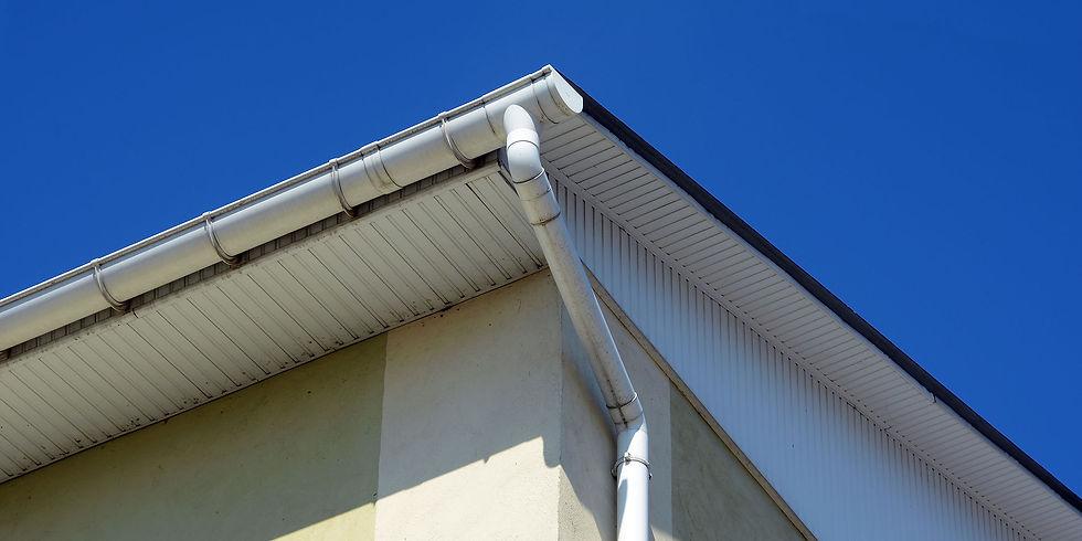 White rain gutters installed on a house roof