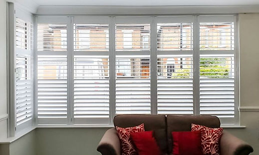 Sleek contemporary kitchen sink area featuring bright white waterproof polymer window shutters