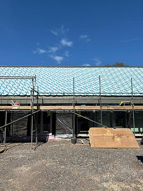 A house under construction with scaffolding covering the front