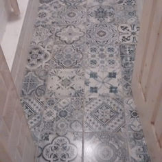 Intricate grey and white patterned vintage-style floor tiles