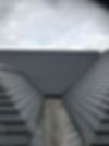 Detailed view of grey roof tiles meeting at a valley junction on a newly repaired domestic property roof