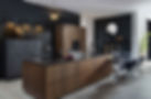 Modern bronze kitchen island with integrated dark wood dining table