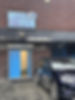 1. A parked car in front of a building displaying a sign that reads "a2b cars