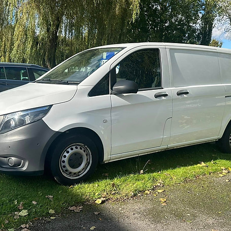 White delivery van parked outside