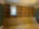 Custom wooden bookshelf, with many shelves, in the room, Bespoke Carpentry and Joinery.