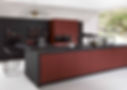 Contemporary matte burgundy kitchen cabinets paired with thick black countertops