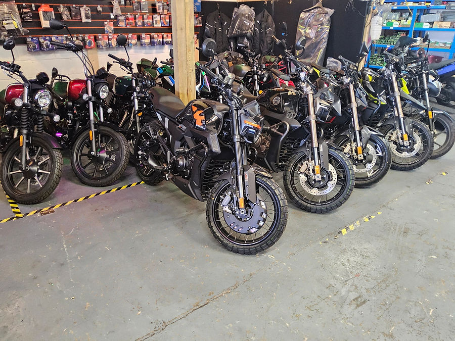 A row of sleek, modern motorcycles lined up in a showroom