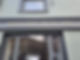 Shopfront sign reading “YSTAFELLOEDD - BWYTAI” above window with street reflection