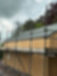 Wooden house under construction with scaffolding on a cloudy day