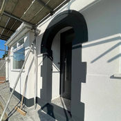Archway entrance above front door with fresh white render