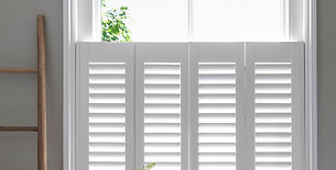 Chic cafe style window shutters covering the lower half of a window to maximise daylight