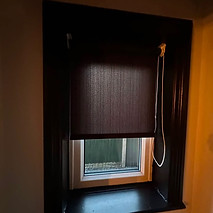 Pull-down roller blind fitted over an interior window