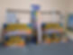 Brightly colored signs for Cwmann Car Wash are displayed against a wall