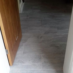 ark grey slate-style floor tiles visible through an open wooden doorway