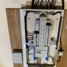 A panel featuring various wires connected to it, showcasing a complex electrical setup