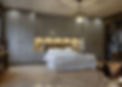 Modern bedroom featuring a large bed with white linens, surrounded by gray built-in wardrobes