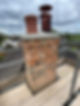 Restored brick chimney stack with fresh mortar