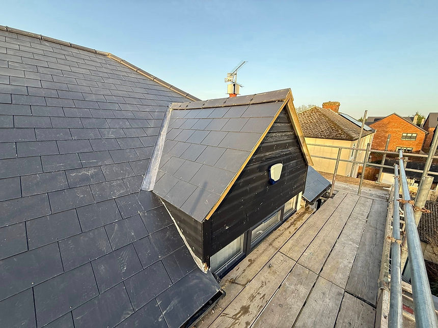 A roof covered with black slate shingles, showcasing a sleek and modern design