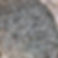 A close-up of a pile of small, irregularly shaped gray stones, creating a rough texture