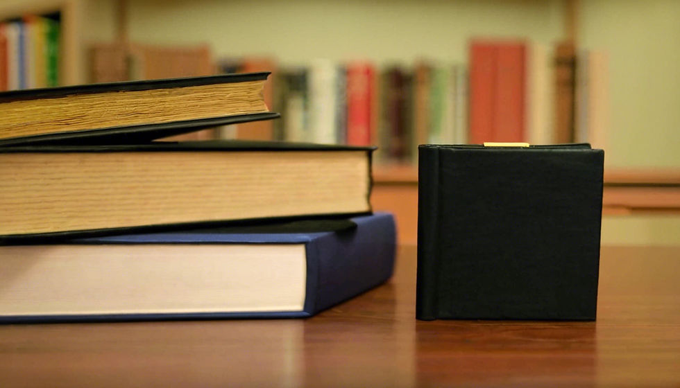 Eye-level view of a stack of law books on a wooden table