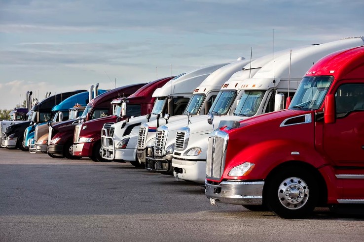 U.S. trucking demand declined approximately 33% between April and October 2025, showing severe slowdown despite the pre-holiday peak season. Tariff pressures, excess capacity, and elevated inventory levels are weakening the sector's outlook.