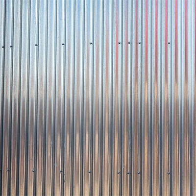 Corrugated metal siding texture with vertical ridges and subtle color variations.