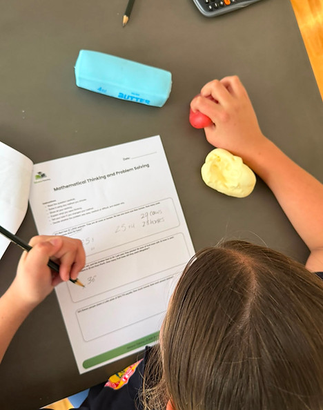A female tutor explaining a geometry problem to a student on a whiteboard.