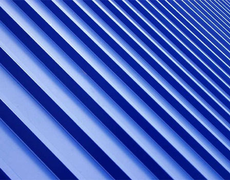 Abstract view of blue siding with angled lines and repeating pattern