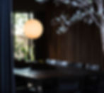 dark dining room with timber feature wall