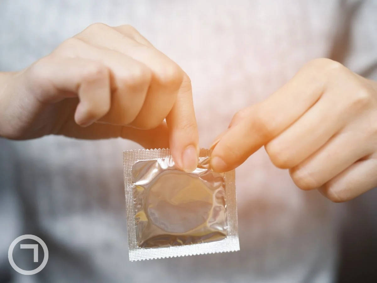 man opening packet of condom