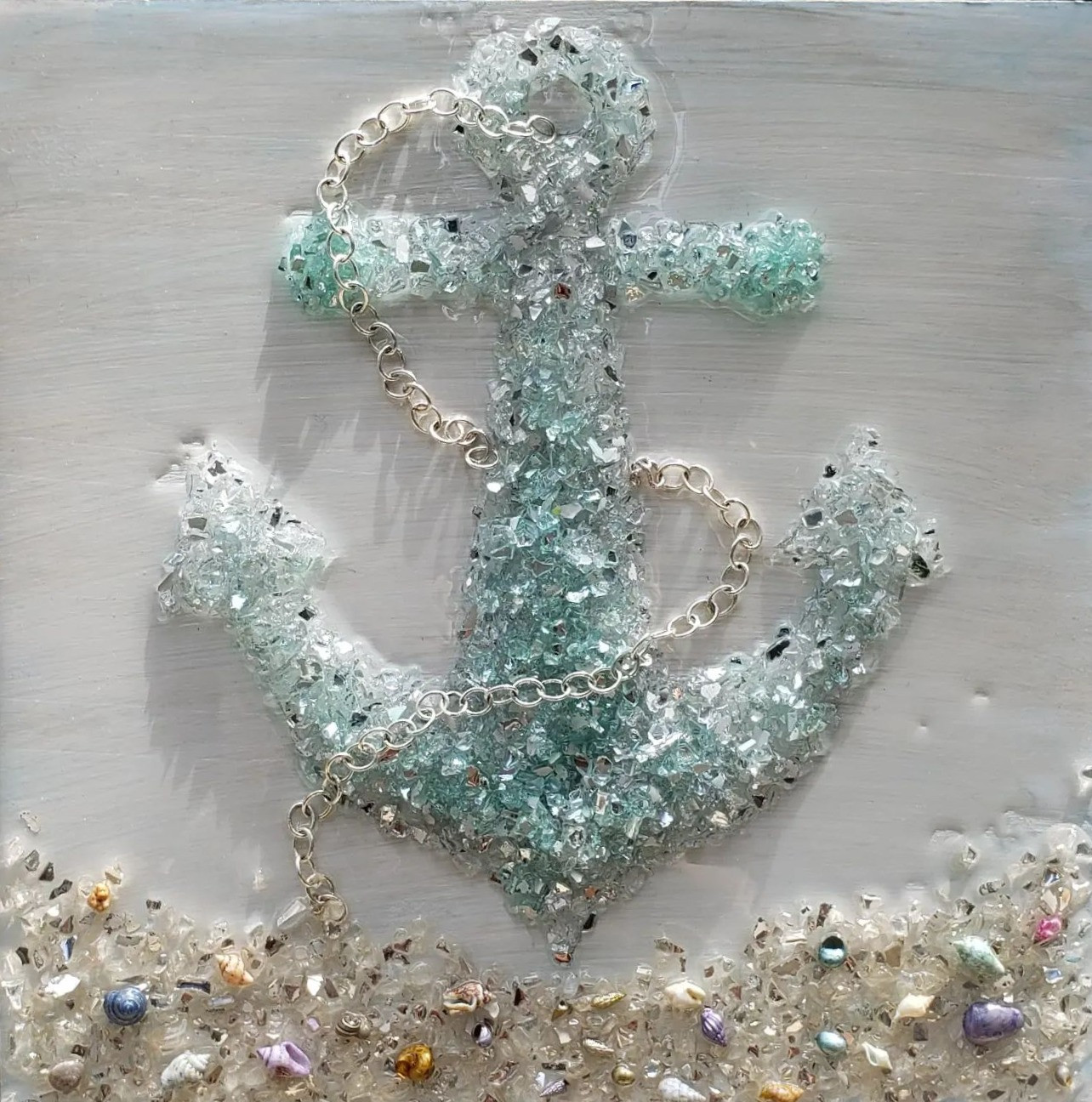Anchors away! Lovely anchor laid out in crushed glass and adorned with genuine shells and retro jewelry.