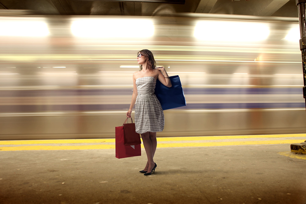 woman waiting for train with luggage