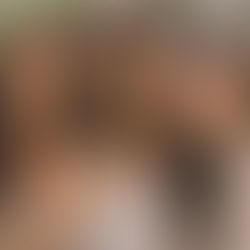 Three women smiling outdoors on a sunny day, wearing casual tops. Green foliage in the background, creating a warm, cheerful mood.